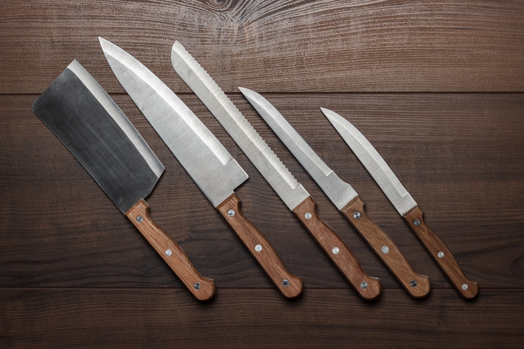 Kitchen Knifes On The Brown Wooden Table